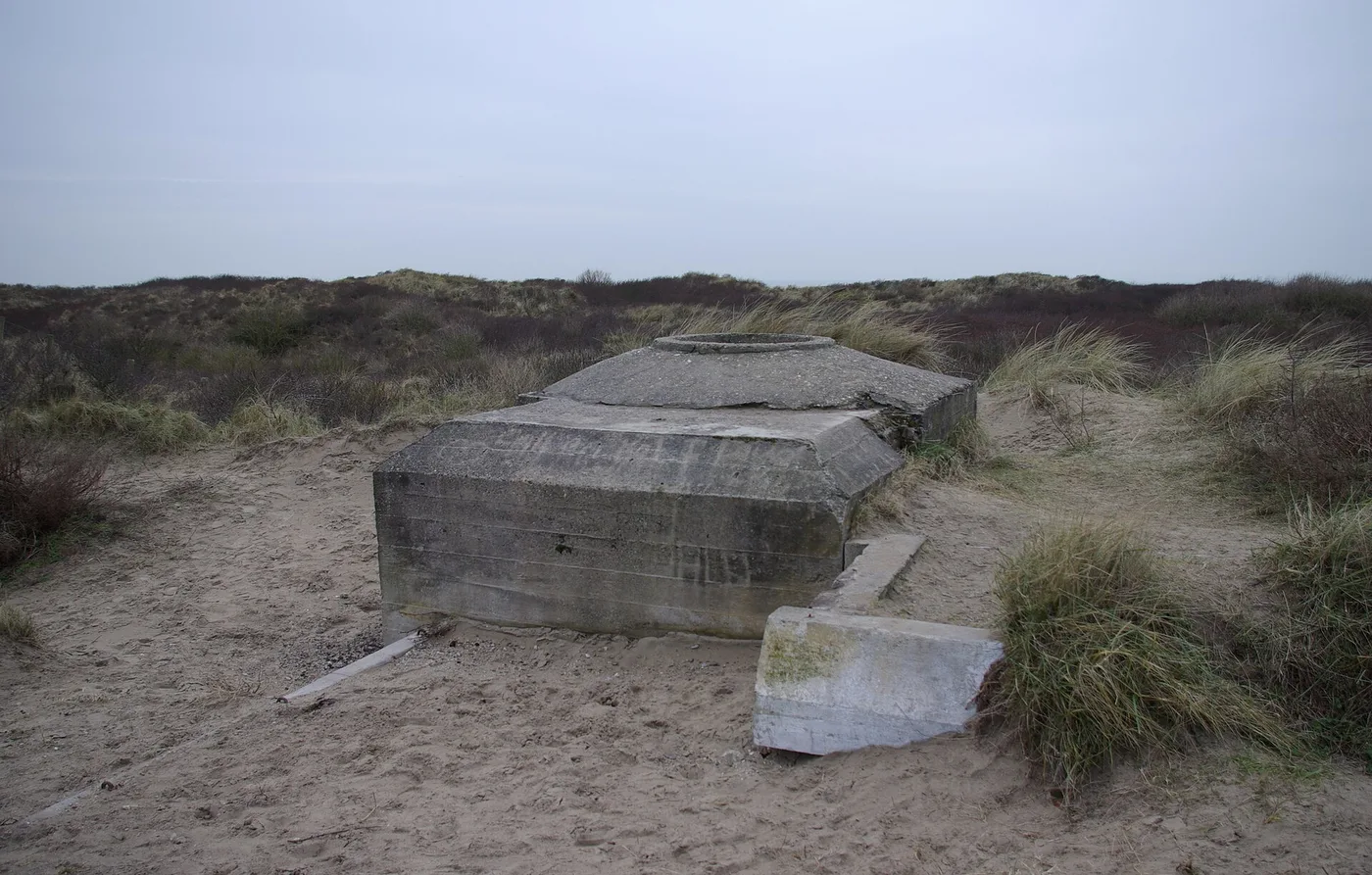 Low abandoned concrete flak bunker of Marine-Flak-Batterie Olmen in the dune sand near IJmuiden