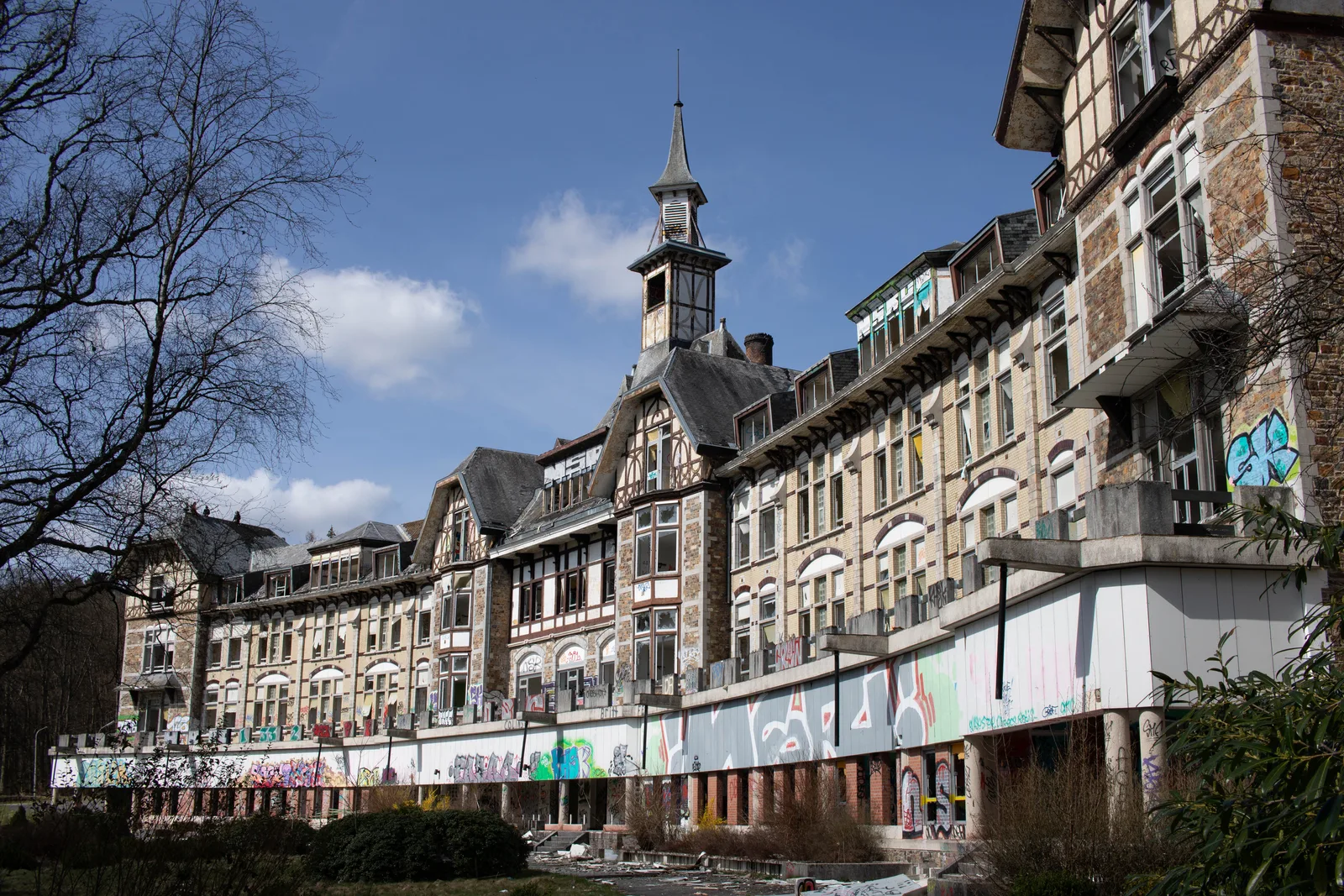 Abandoned, graffiti-covered façade of the Borgoumont sanatorium (Sanatorium du Basil) in Stoumont