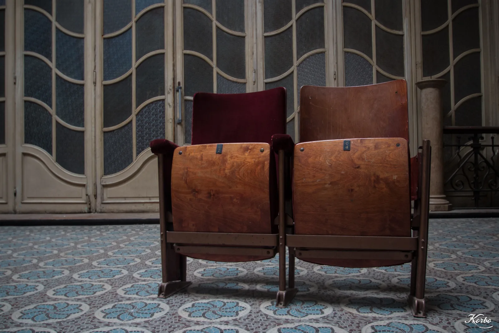 Abandoned wooden seats in a hall of the Aegidium theatre in Saint-Gilles, Brussels, with Art Nouveau floors and walls