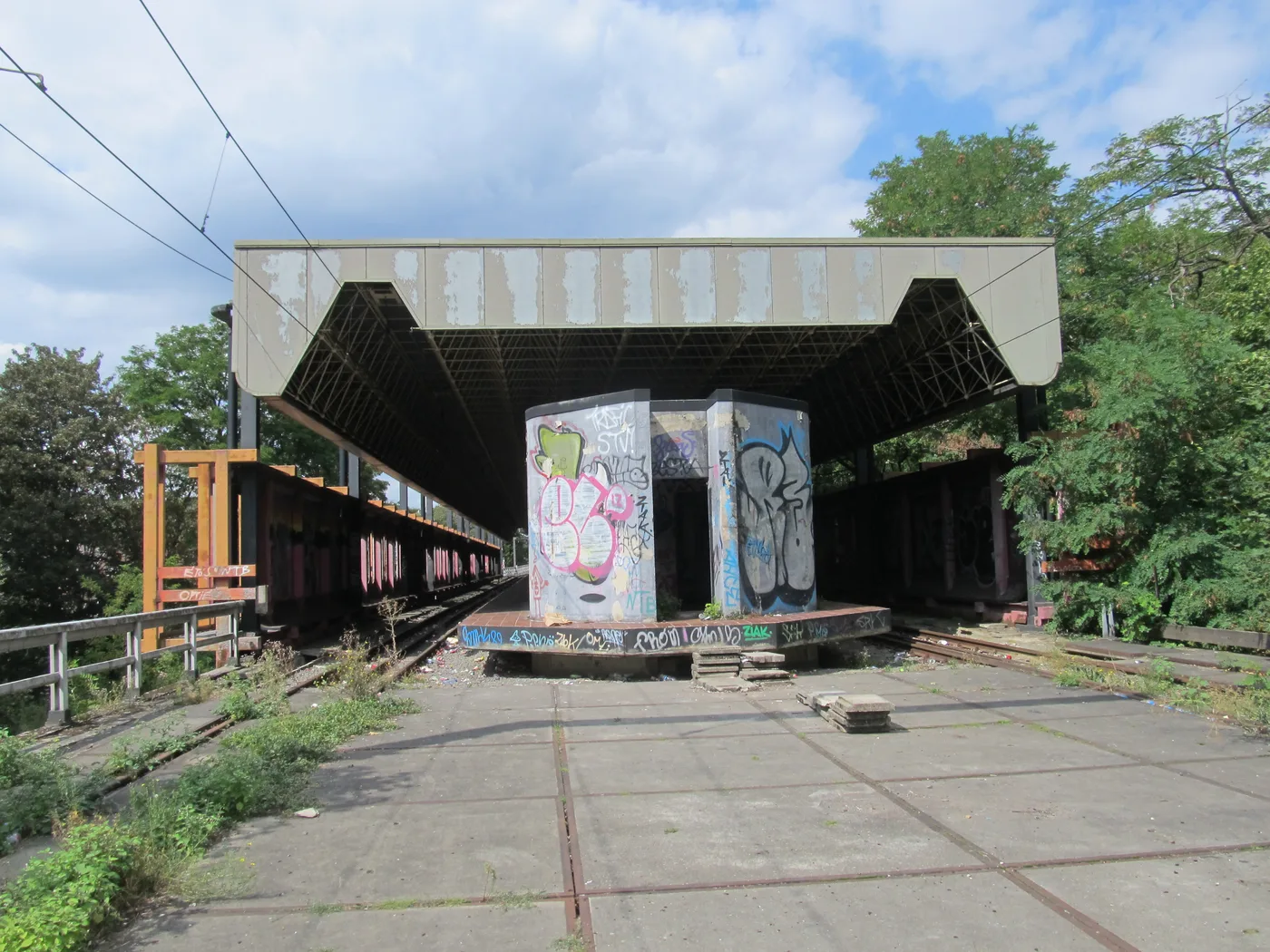 The graffiti-covered platform and tracks of the Chêt ghost station on Charleroi's abandoned metro