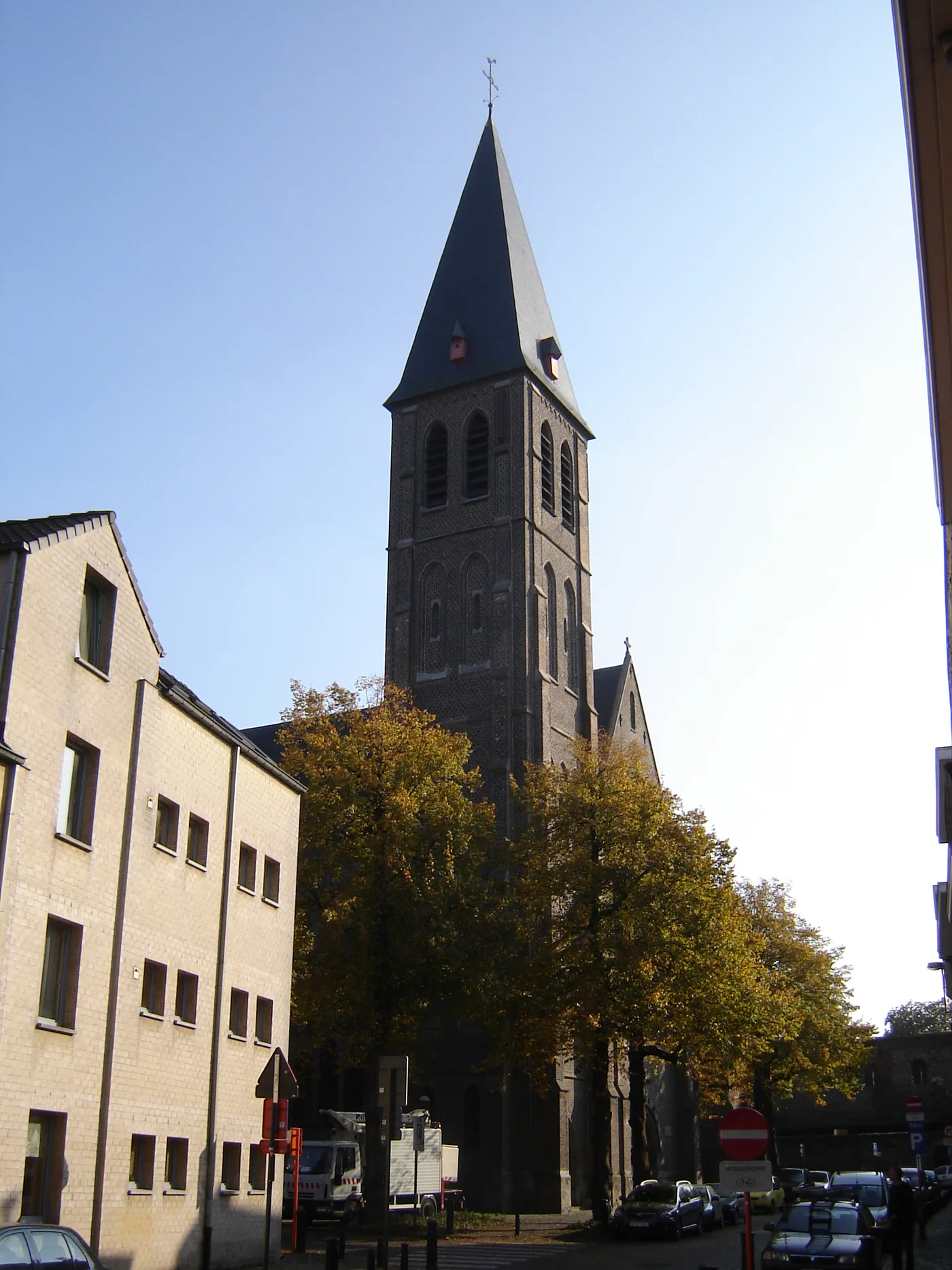 The tower and spire of the neo-Gothic Sint-Macharius church in Ghent, seen from the street