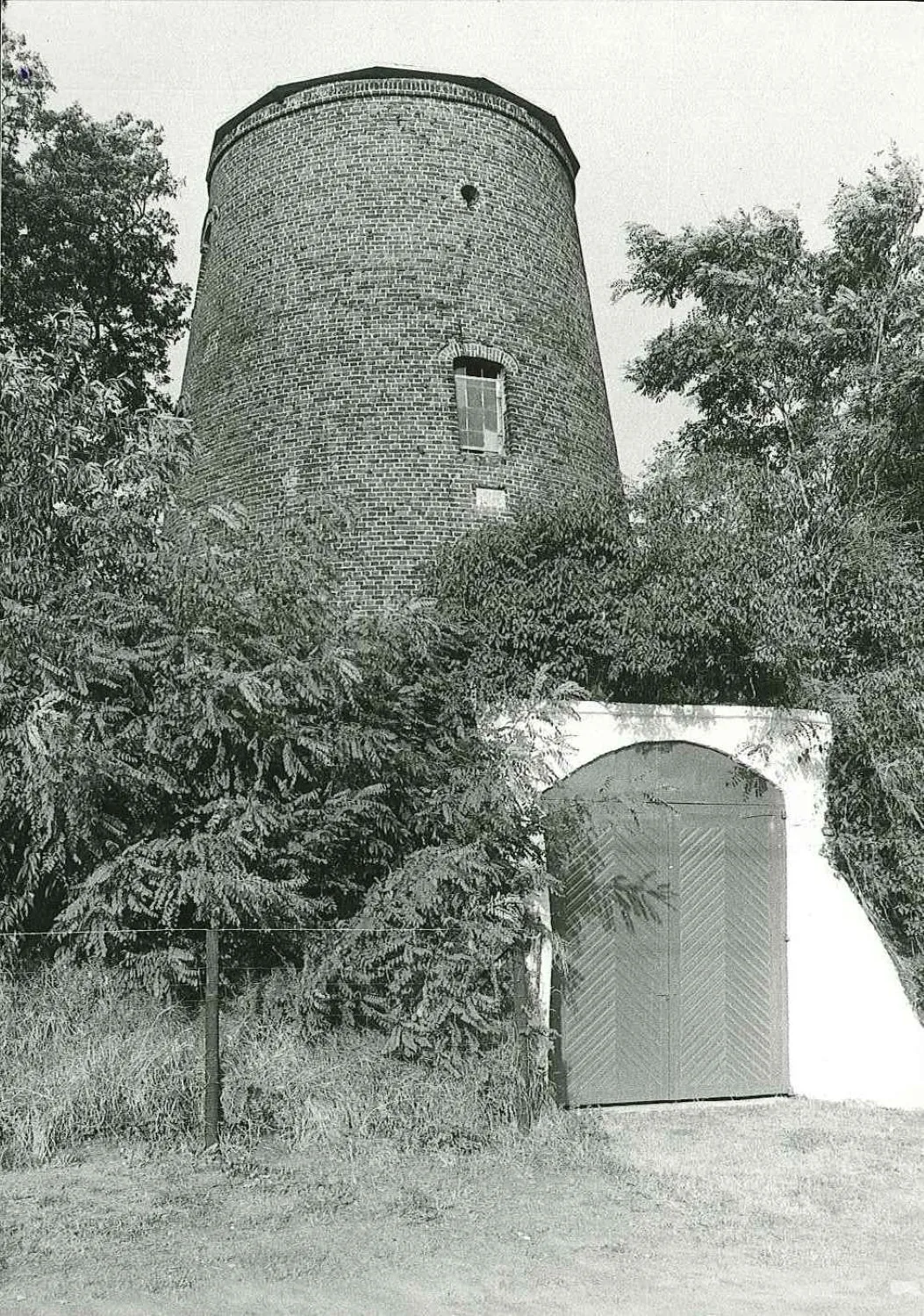 The brick body of the Remuemolen, an abandoned tower mill in Destelbergen near Ghent