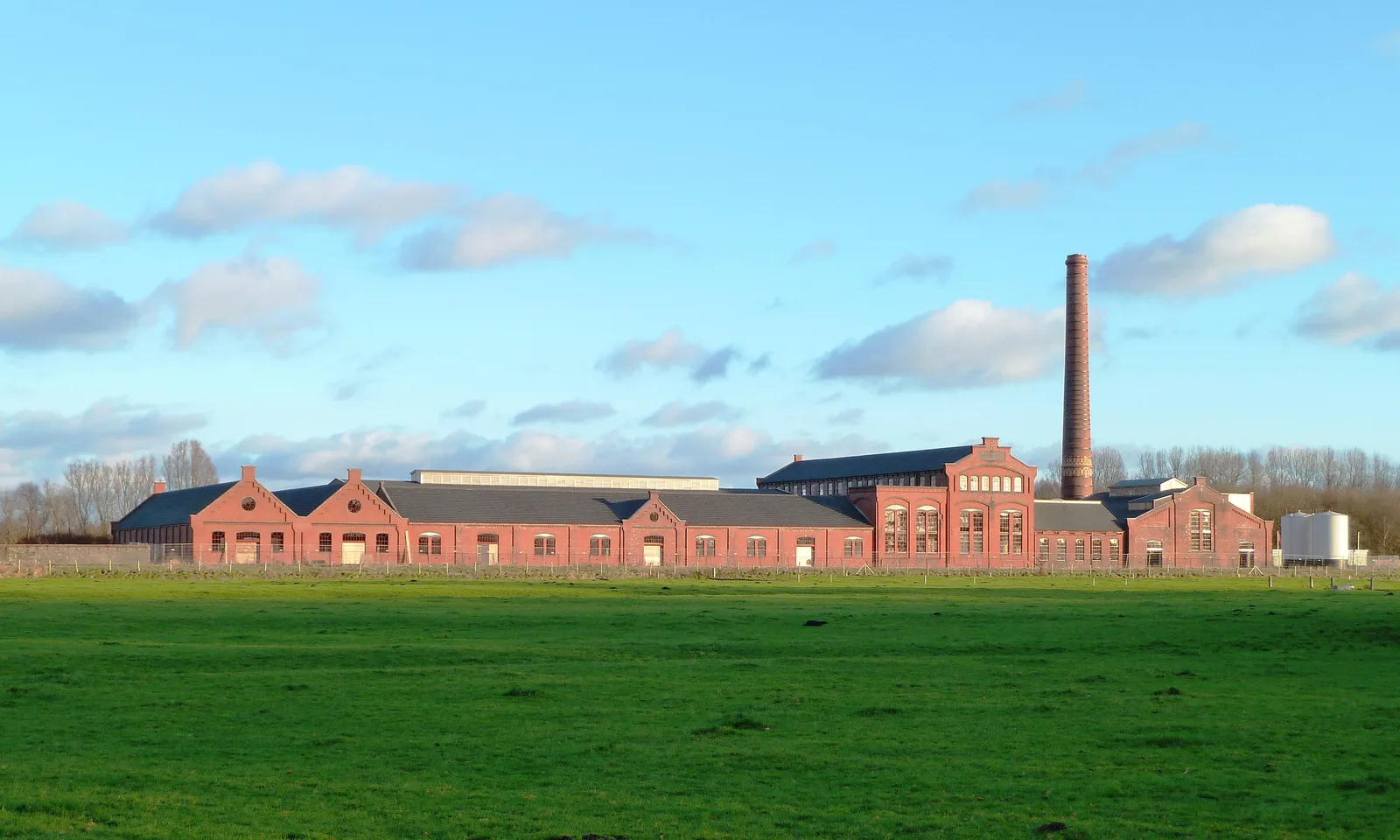 The old De Toekomst II strawboard factory in Scheemda with red brick and a tall chimney