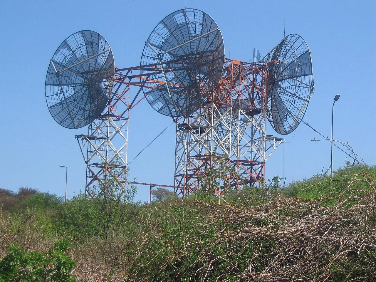 Abandoned and rusted NATO radio relay station with large dish antennas in the Vinetaduin near Hoek van Holland